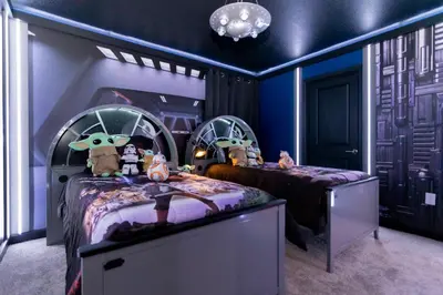a childs room with two beds with toy characters on them at Brand New 9 Bedroom Single Family Storey Lake 18ST in Kissimmee