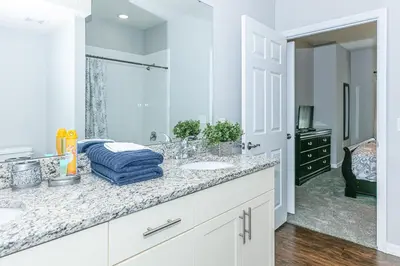a white bathroom with a sink and a mirror at Comfy and Spacious House in Kissimmee