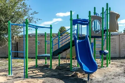 a playground with a blue slide in a park at Comfy and Spacious House in Kissimmee