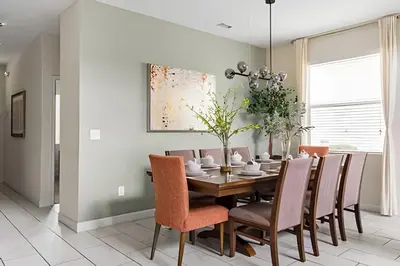 a dining room with a table and chairs at Casa 5Q c/ Piscina Sul e Game Room – Storey Lake in Kissimmee