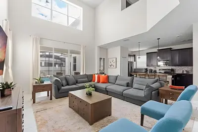 a living room with a couch and a table at Casa 5Q c/ Piscina Sul e Game Room – Storey Lake in Kissimmee