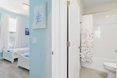 a white bathroom with a toilet and a sink at Casa 6Q c/ Piscina & Quartos Temáticos in Kissimmee