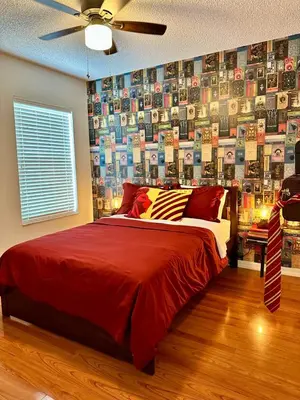 a bedroom with a bed and a wall of books at Disney Pixie Dust Villa in Kissimmee