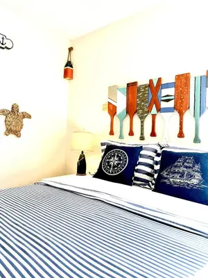 a bedroom with a bed with blue and white stripes at Disney Pixie Dust Villa in Kissimmee