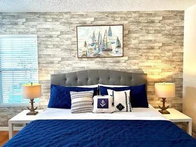 a bedroom with a blue bed with two lamps at Disney Pixie Dust Villa in Kissimmee