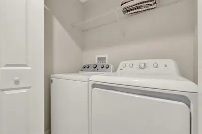 a kitchen with a white stove and a washer at TVPM-4981WA/SL in Kissimmee