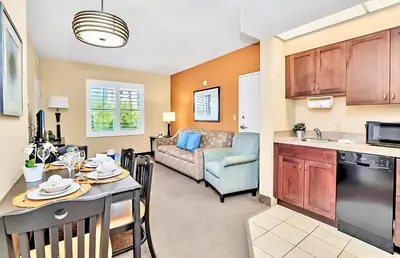 a kitchen and living room with a table and a couch at Family-Friendly 1BR Apartment close to Disney World in Orlando