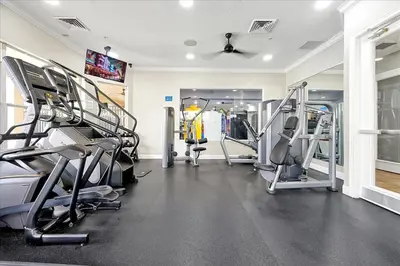a gym with several tread machines in a room at Disney Dream in Orlando
