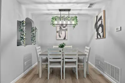 a dining room with a table and chairs at Red Jordan Boho Style Vacation Home in Orlando