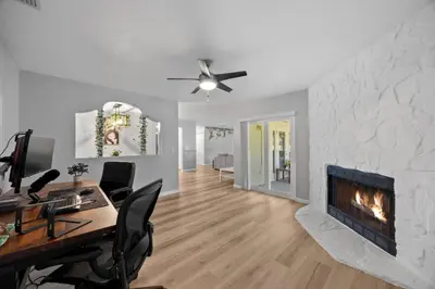 a living room with a desk and a fireplace at Red Jordan Boho Style Vacation Home in Orlando