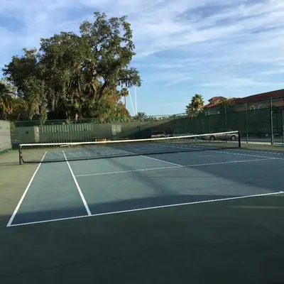 a tennis court with a net on top of it at Spacious 4 BR Townhouse with 2 King Size Master Bedrooms, 3 miles to Disney, Free WiFi and Free Parking in Orlando