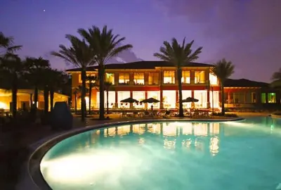 a large swimming pool in front of a building at Spacious 4 BR Townhouse with 2 King Size Master Bedrooms, 3 miles to Disney, Free WiFi and Free Parking in Orlando