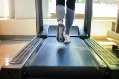 a person is running on a treadmill at Secret Resort Kissimmee Lakeview Condo in Kissimmee