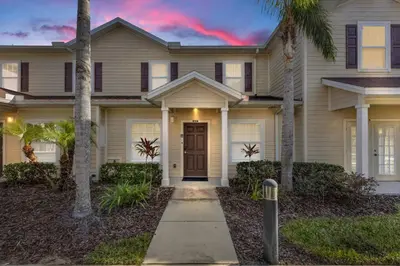 a house with palm trees in front of it at Magical Disney Getaway- Belle Potter & Minions in Kissimmee