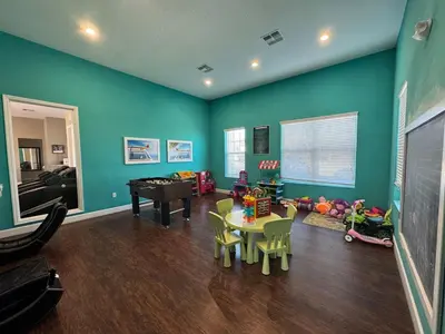 a living room with blue walls and a table and chairs at Magical Disney Getaway- Belle Potter & Minions in Kissimmee