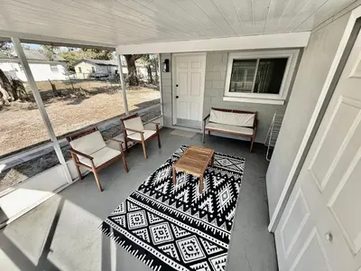 a porch with a table and chairs on a house at Relaxing 3BR Home Near Orlando Downtown & Parks in Orlando