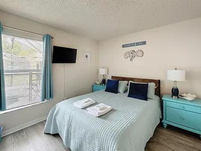 a bedroom with a bed with blue furniture and a window at Family Fun Tropical Home in Kissimmee