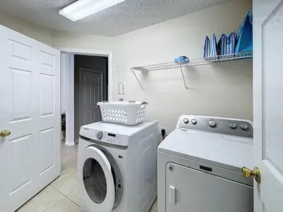 a laundry room with a washer and dryer at Family Fun Tropical Home in Kissimmee