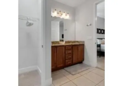 a bathroom with a sink and a mirror at 321 PC - Encore Oasis Luxury 5BR Home Private Pool in Orlando