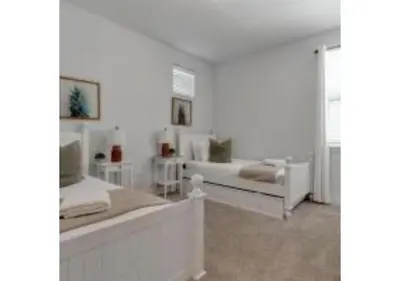 a white bedroom with two beds and a mirror at 321 PC - Encore Oasis Luxury 5BR Home Private Pool in Orlando