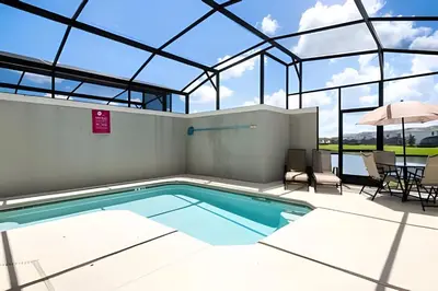 a swimming pool in a building with a glass ceiling at Casa 4Q c/ Piscina e Temas Mickey & Harry Potter in Kissimmee