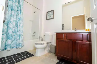 a bathroom with a toilet and a sink and a shower at Family Friendly 12Bd w Jacuzzi Veranda Palms 4401 in Kissimmee