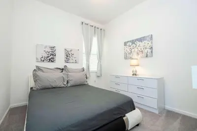a bedroom with a bed and a dresser in it at Family Friendly 12Bd w Jacuzzi Veranda Palms 4401 in Kissimmee
