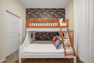 a childs bedroom with a bunk bed and a ladder at Cozy 2 Bedrooms At Storey Lake in Kissimmee