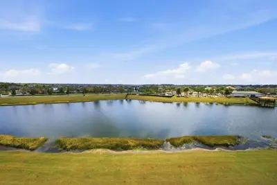 an aerial view of a large pond on a golf course at Cozy 2 Bedrooms At Storey Lake in Kissimmee