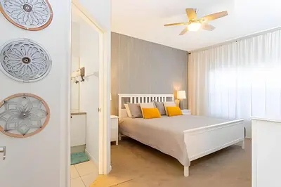a bedroom with a bed and a clock on the wall at Casa 4Q Disney c/ Piscina e Quartos Temáticos in Kissimmee