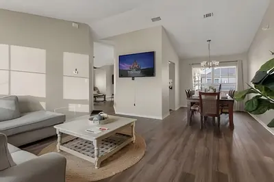 a living room with a couch and a table at Casa 4Q c/ Piscina e Game Room – Perto Disney in Orlando
