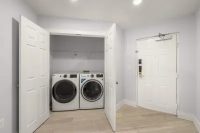 a white laundry room with a washer and dryer at Sleek & Stylish Stay Mins to Magic MP68 in Orlando