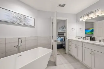 a white bathroom with a tub and a sink at Sleek & Stylish Stay Mins to Magic MP68 in Orlando