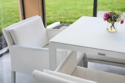 a white table and chairs with a vase of flowers at Sleek & Stylish Stay Mins to Magic MP68 in Orlando
