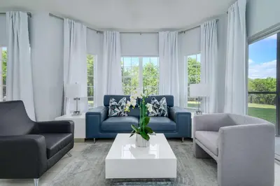 a living room with two blue couches and a table at Sleek & Stylish Stay Mins to Magic MP68 in Orlando