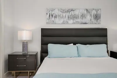 a bedroom with a large bed with a black headboard at Serene Disney Getaway Designer Style MP61 in Orlando