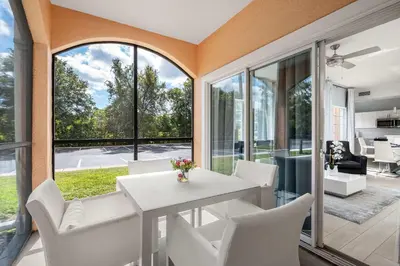 a dining room with a white table and chairs at Serene Disney Getaway Designer Style MP61 in Orlando