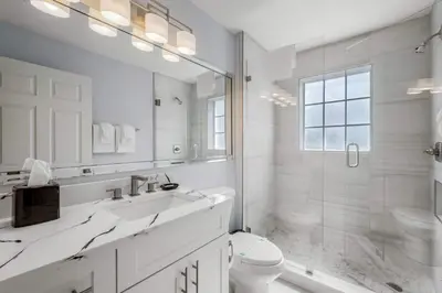 a white bathroom with a shower and a toilet at Serene Disney Getaway Designer Style MP61 in Orlando