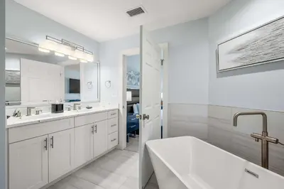 a white bathroom with a tub and a sink at Serene Disney Getaway Designer Style MP61 in Orlando