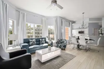 a living room with a blue couch and a table at Designer Retreat 2 Miles to Disney MP21 in Orlando