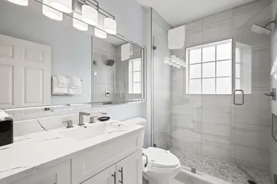 a bathroom with a sink and a toilet and a mirror at Designer Retreat 2 Miles to Disney MP21 in Orlando