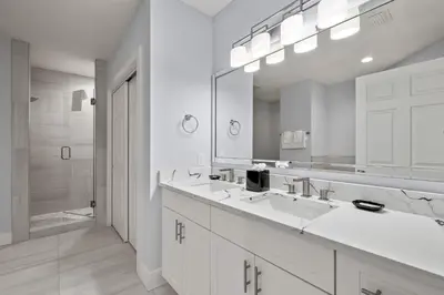 a bathroom with two sinks and a large mirror at Designer Retreat 2 Miles to Disney MP21 in Orlando