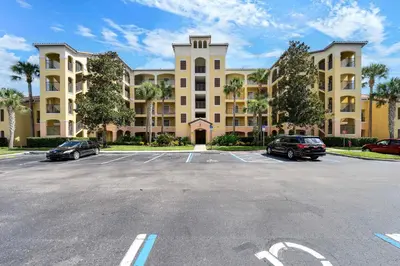 a parking lot in front of a large building at Designer Retreat 2 Miles to Disney MP21 in Orlando
