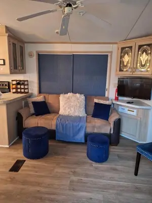 a living room with a couch and two blue stools at A house near Disney and Universal - mikeyfl-1 in Kissimmee