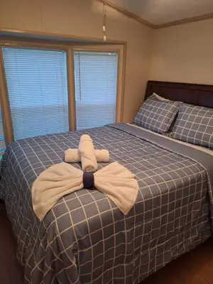 a bed with a blanket with a bow on it at A house near Disney and Universal - mikeyfl-1 in Kissimmee