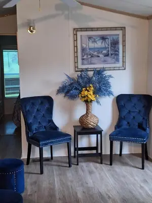 two blue chairs and a vase with flowers on a table at A house near Disney and Universal - mikeyfl-1 in Kissimmee