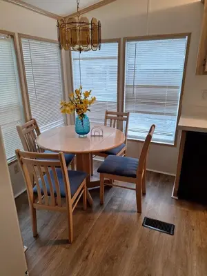 a dining room table with chairs and a vase of flowers at A house near Disney and Universal - mikeyfl-1 in Kissimmee