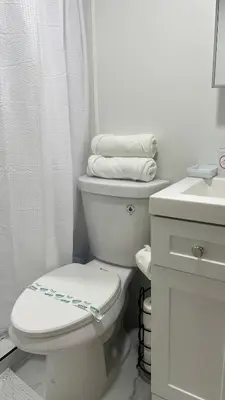 a white bathroom with a toilet and a sink at A house near Disney and Universal - mikeyfl-1 in Kissimmee