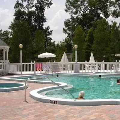 a woman is in a swimming pool at A house near Disney and Universal - mikeyfl-1 in Kissimmee