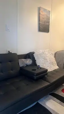 a black couch with a laptop on top of it at Casita próximo Disney - mickeyfl-2 in Kissimmee